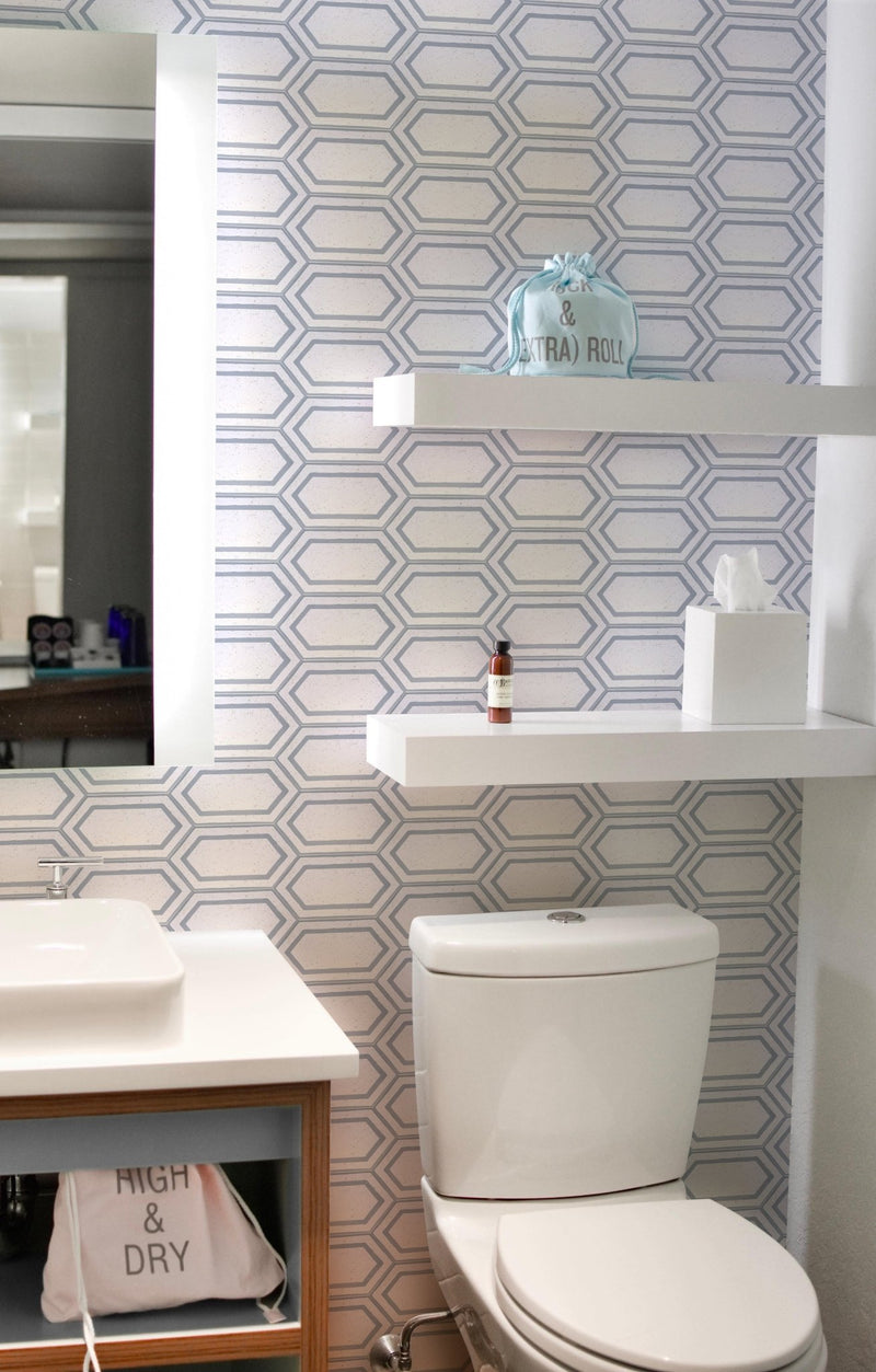 An elongated hexad backsplash of our sophisticated Tiffany Mother of Pearl cement tiles on the bathroom walls.